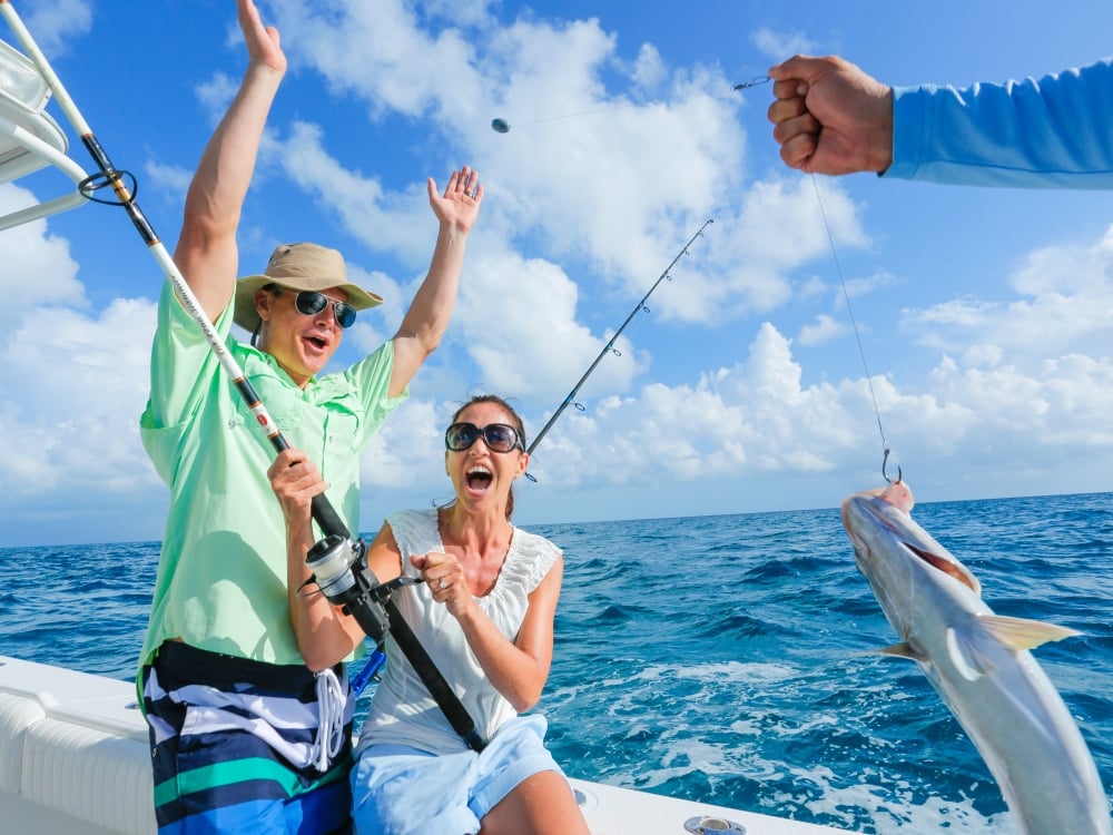Couple celebrating catching a fish